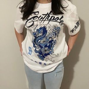 white and blue graphic tee